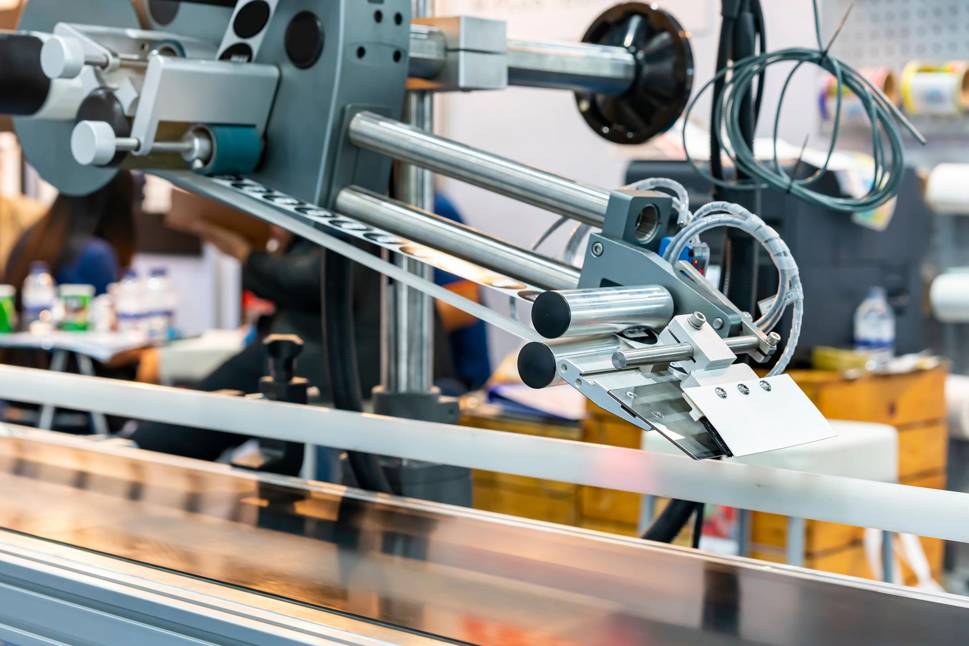 automatic continuous labeling machine for labelling product on belt conveyor in manufacturing process in industrial